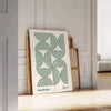 Poster showing Bauhaus abstract geometric composition in minimalist modern style - leaning on a herringbone floor against a white panelled wall