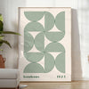 Poster showing Bauhaus abstract geometric composition in minimalist modern style - in a bright minimalist room with a plant and an armchair