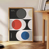Formas geométricas abstractas en estilo Bauhaus con colores primarios audaces - junto a una mesa auxiliar redonda de madera con libros