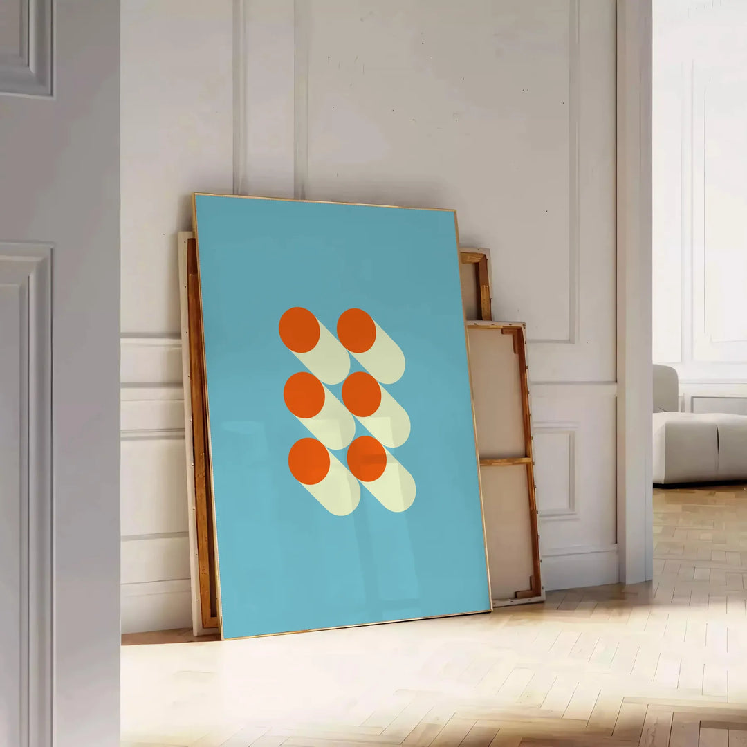 Bauhaus geometric abstract poster with bold red, blue, yellow shapes - leaning on a herringbone floor against a white panelled wall