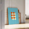 Bauhaus geometric abstract poster with bold red, blue, yellow shapes - leaning on a herringbone floor against a white panelled wall