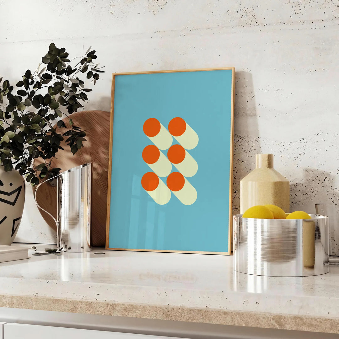 Bauhaus geometric abstract poster with bold red, blue, yellow shapes - styled on a counter with eucalyptus and a bowl of lemons