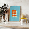Bauhaus geometric abstract poster with bold red, blue, yellow shapes - styled on a counter with eucalyptus and a bowl of lemons