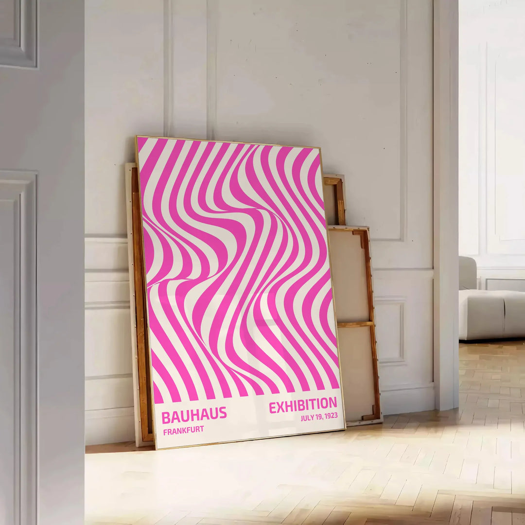 Unframed brown and pink Bauhaus geometric abstract poster - leaning on a herringbone floor against a white panelled wall