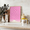 Unframed brown and pink Bauhaus geometric abstract poster - styled on a counter with eucalyptus and a bowl of lemons