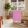 Unframed brown and pink Bauhaus geometric abstract poster - in a Parisian living room with a sofa and a fig plant