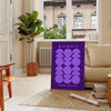 Purple and white geometric Bauhaus poster, bold minimalist shapes on paper - in a Parisian living room with a sofa and a fig plant