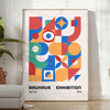 Bauhaus geometric abstract poster with orange and blue minimalist shapes - in a bright minimalist room with a plant and an armchair
