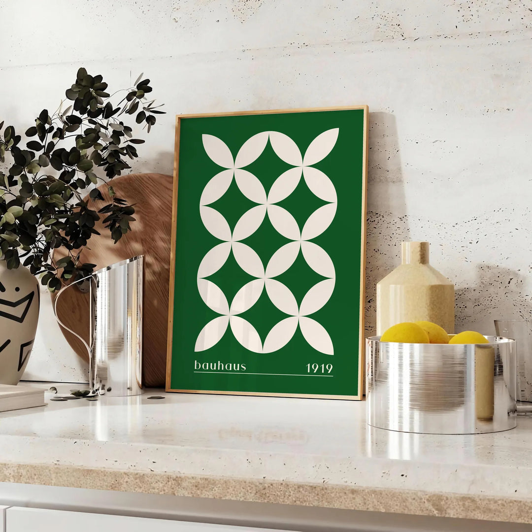 Green and white poster featuring abstract geometric shapes in Bauhaus style - styled on a counter with eucalyptus and a bowl of lemons