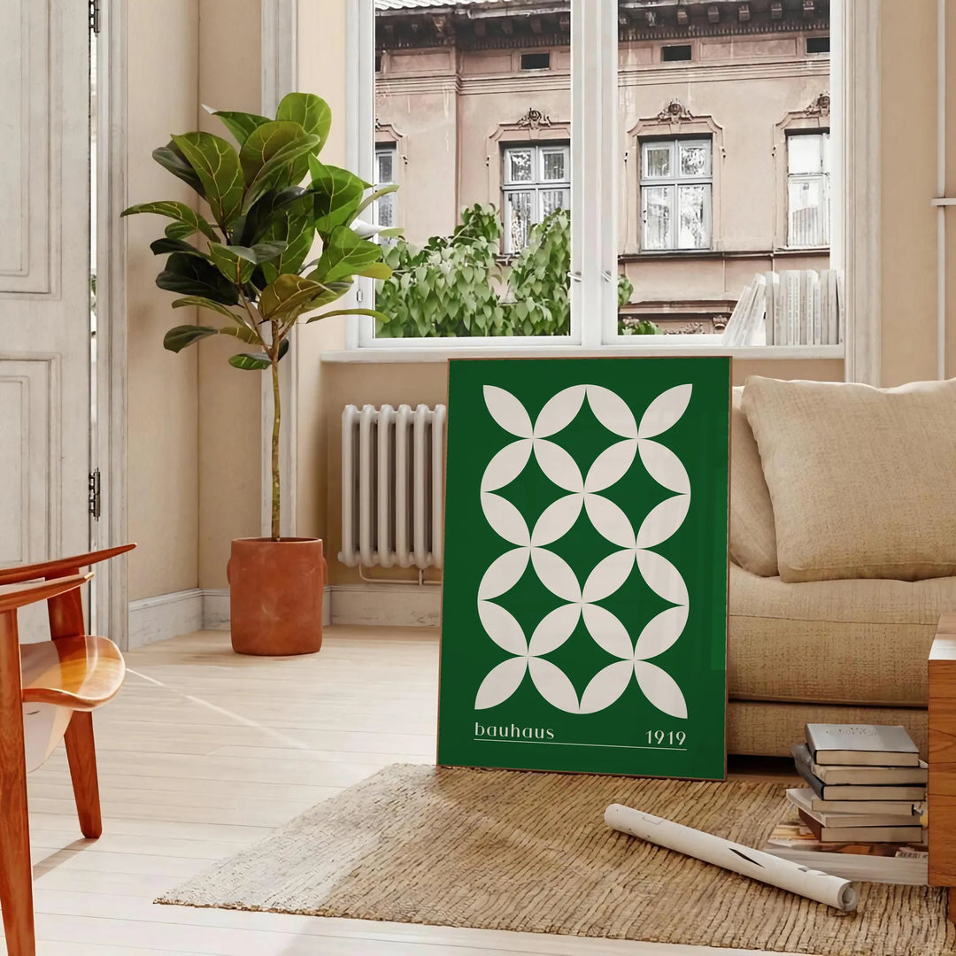 Green and white poster featuring abstract geometric shapes in Bauhaus style - in a Parisian living room with a sofa and a fig plant