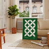 Green and white poster featuring abstract geometric shapes in Bauhaus style - in a Parisian living room with a sofa and a fig plant
