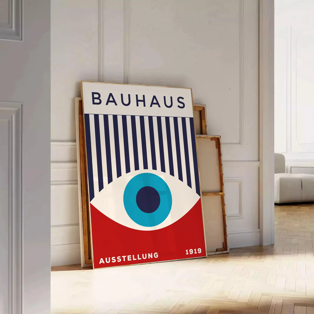 Bauhaus geometric poster with blue and red abstract shapes - leaning on a herringbone floor against a white panelled wall