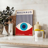 Bauhaus geometric poster with blue and red abstract shapes - styled on a counter with eucalyptus and a bowl of lemons