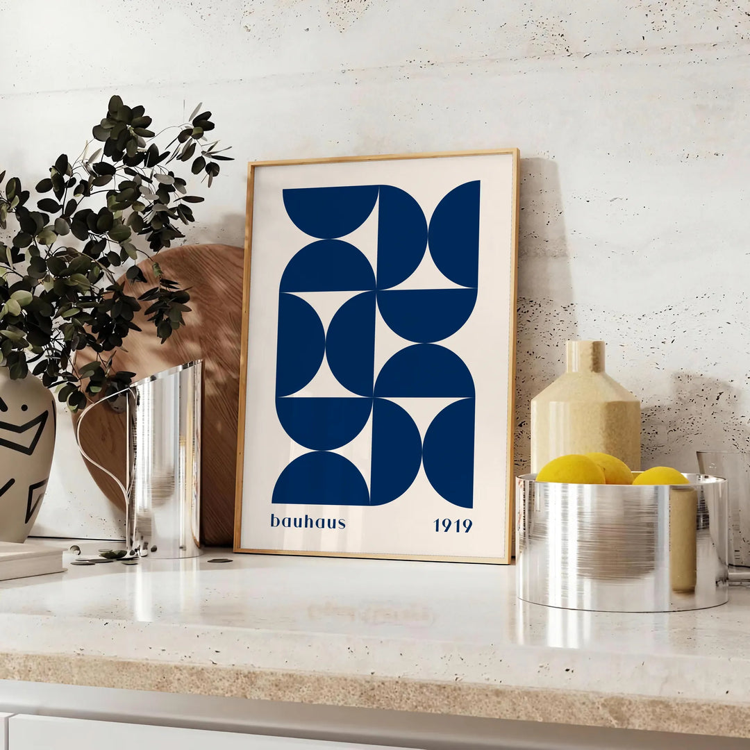 Vintage Bauhaus poster featuring geometric shapes in muted colors - styled on a counter with eucalyptus and a bowl of lemons