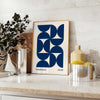 Vintage Bauhaus poster featuring geometric shapes in muted colors - styled on a counter with eucalyptus and a bowl of lemons