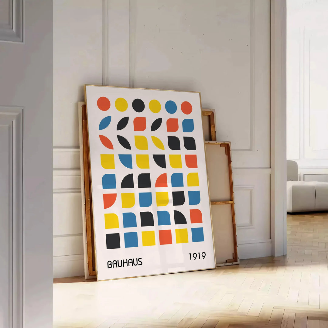Bauhaus style abstract design with dynamic shapes in orange and blue - leaning on a herringbone floor against a white panelled wall