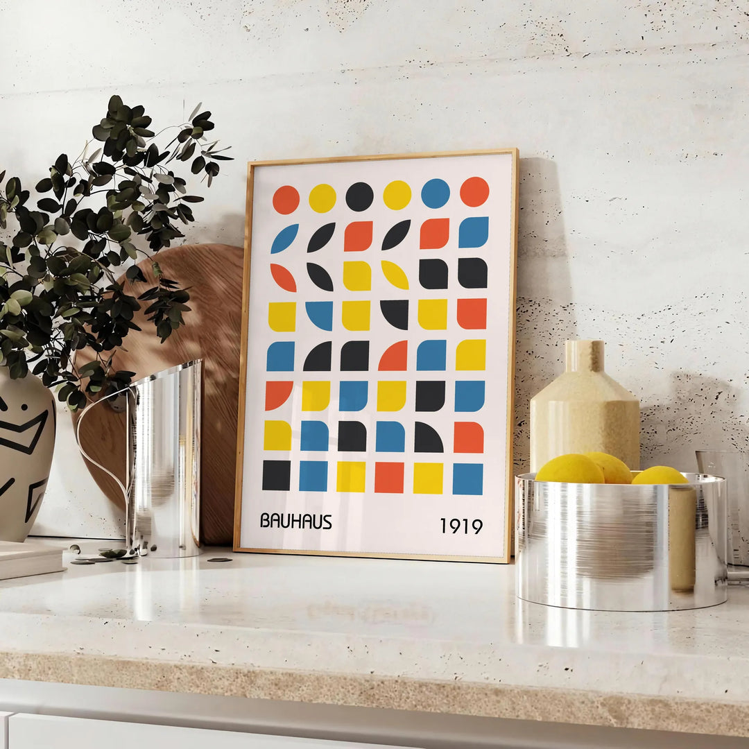 Bauhaus style abstract design with dynamic shapes in orange and blue - styled on a counter with eucalyptus and a bowl of lemons