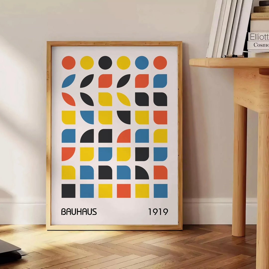 Bauhaus style abstract design with dynamic shapes in orange and blue - beside a round wooden side table with books
