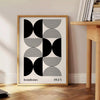 Abstract geometric shapes in Bauhaus style with bold colors - beside a round wooden side table with books