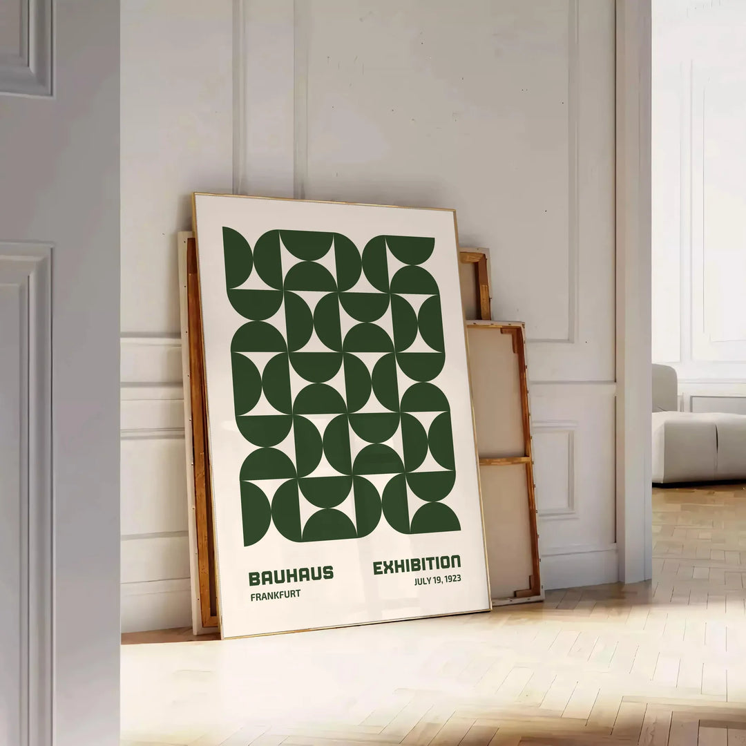 Abstract Bauhaus-inspired design with geometric shapes in gray and green - leaning on a herringbone floor against a white panelled wall