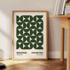 Abstract Bauhaus-inspired design with geometric shapes in gray and green - beside a round wooden side table with books