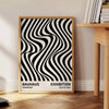 Abstract geometric shapes in Bauhaus style with bold primary colors - beside a round wooden side table with books