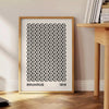 Geometric shapes and lines in Bauhaus style with a minimalist color palette - beside a round wooden side table with books