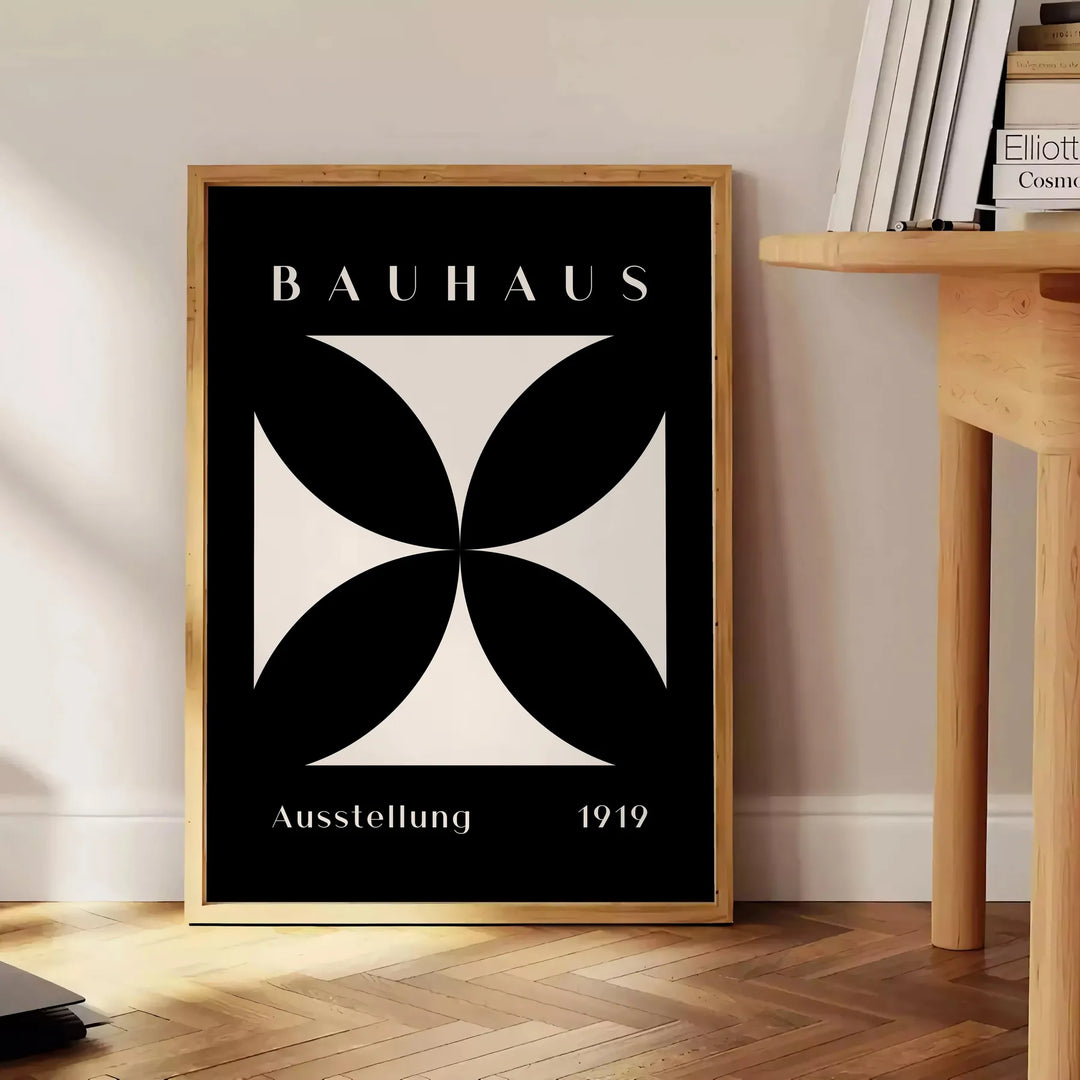 Abstract Bauhaus design with geometric shapes in gray and black tones - beside a round wooden side table with books