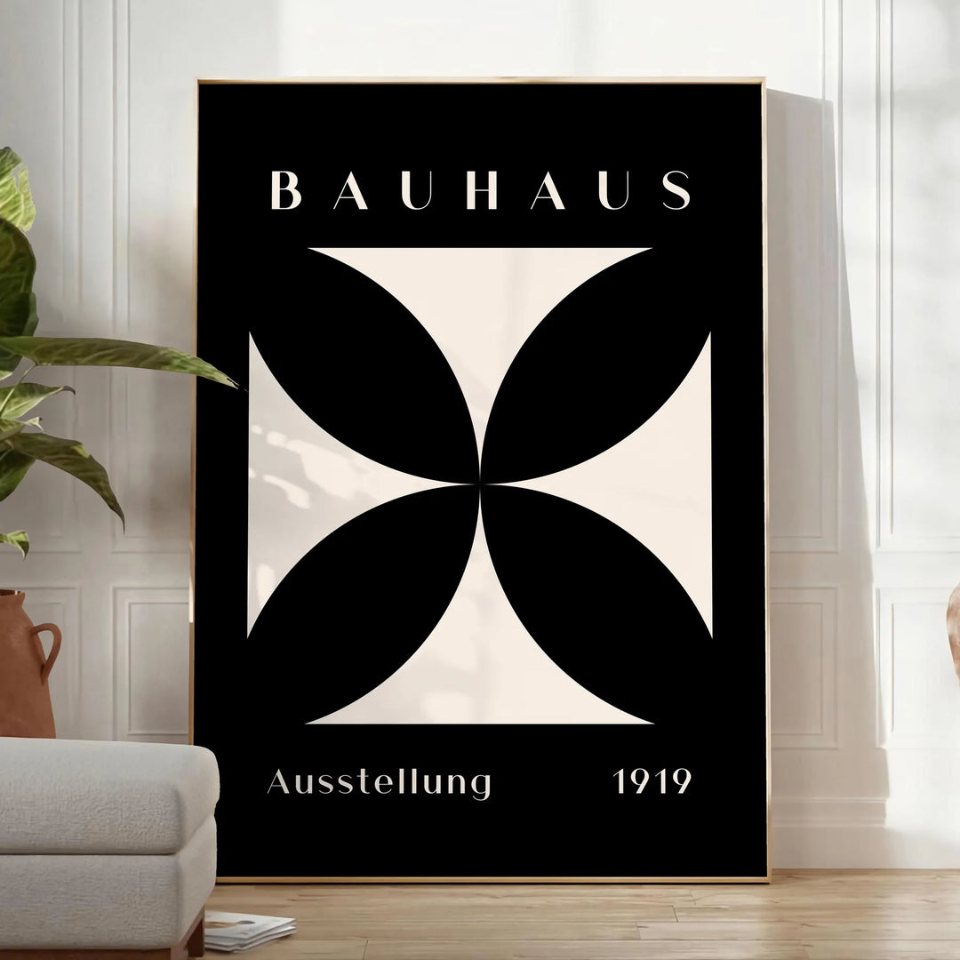 Abstract Bauhaus design with geometric shapes in gray and black tones - in a bright minimalist room with a plant and an armchair