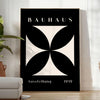 Abstract Bauhaus design with geometric shapes in gray and black tones - in a bright minimalist room with a plant and an armchair