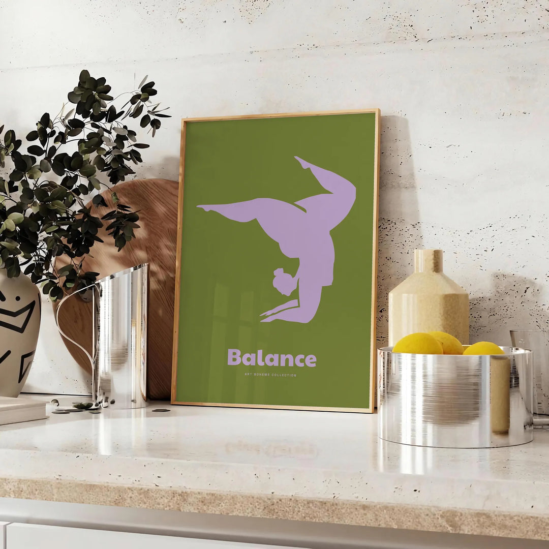 Poster showing minimalist yoga balance silhouette in green and blue watercolor - styled on a counter with eucalyptus and a bowl of lemons