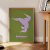 Poster showing minimalist yoga balance silhouette in green and blue watercolor - beside a round wooden side table with books