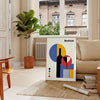 Bauhaus abstract geometric poster with bold primary colors, modern minimal composition - in a Parisian living room with a sofa and a fig plant