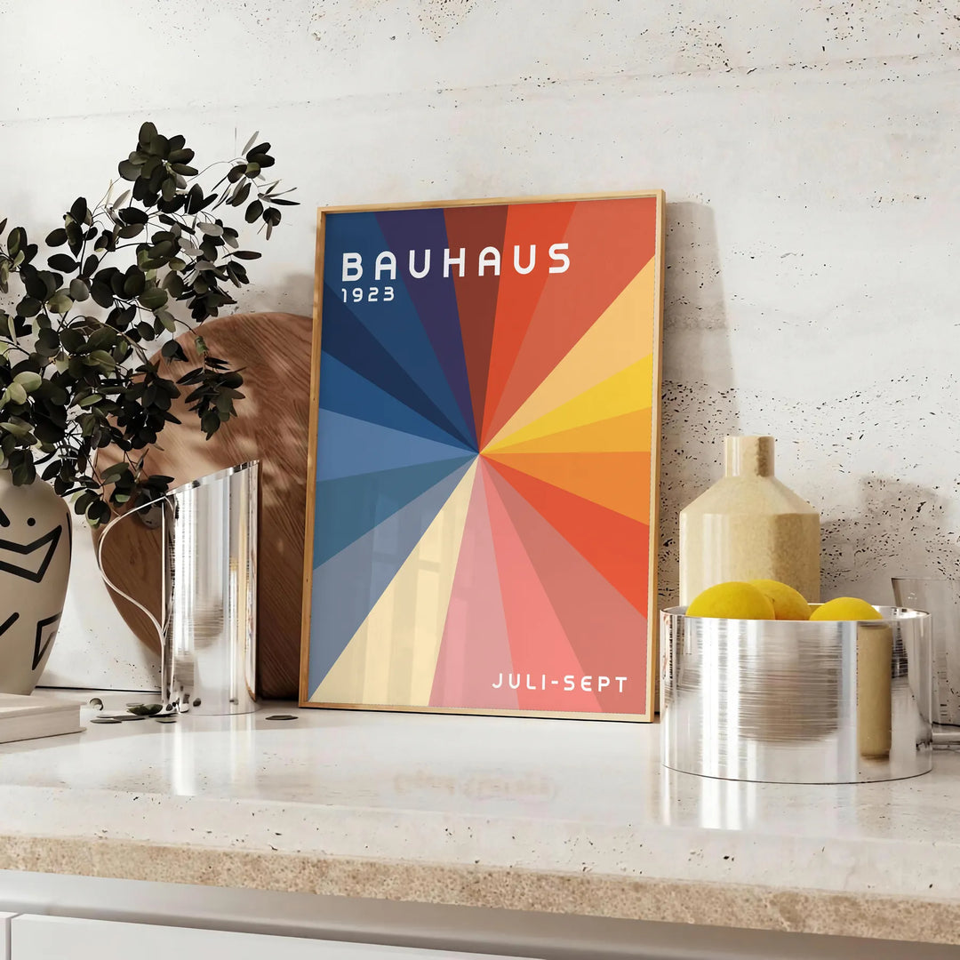 Bauhaus geometric artwork poster with bold primary colors and shapes - styled on a counter with eucalyptus and a bowl of lemons