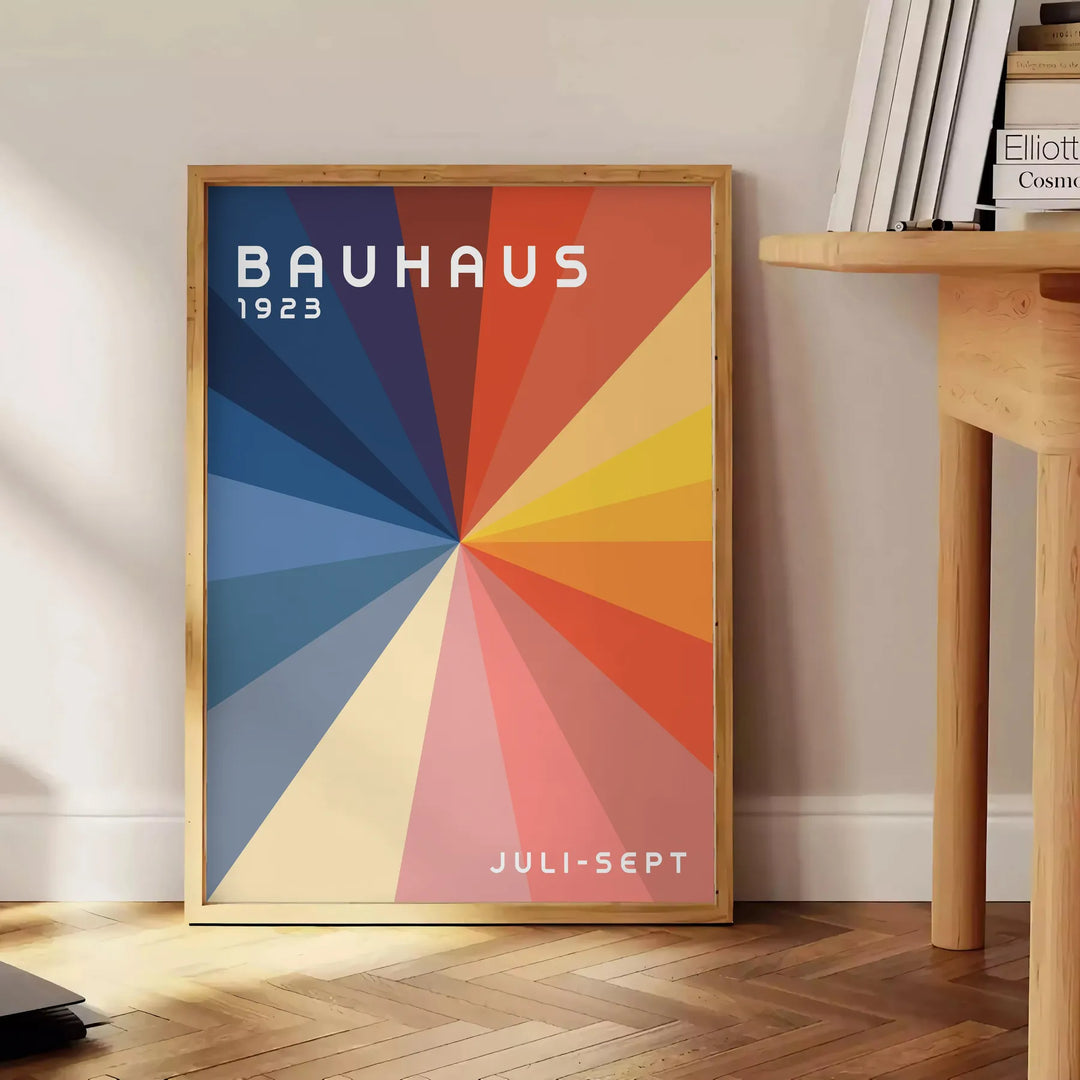 Bauhaus geometric artwork poster with bold primary colors and shapes - beside a round wooden side table with books