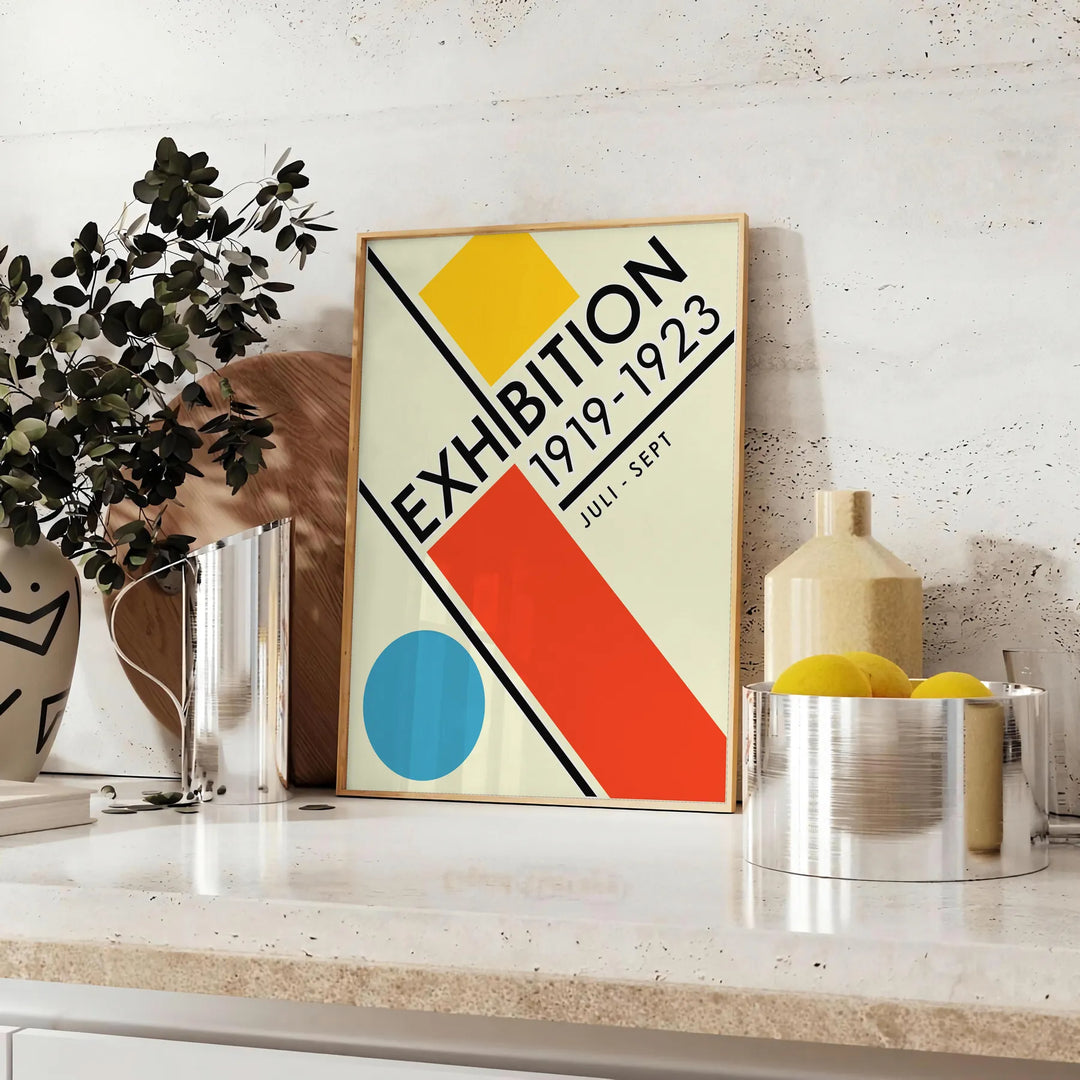 Abstract geometric shapes in a minimal Bauhaus style with a limited color palette - styled on a counter with eucalyptus and a bowl of lemons