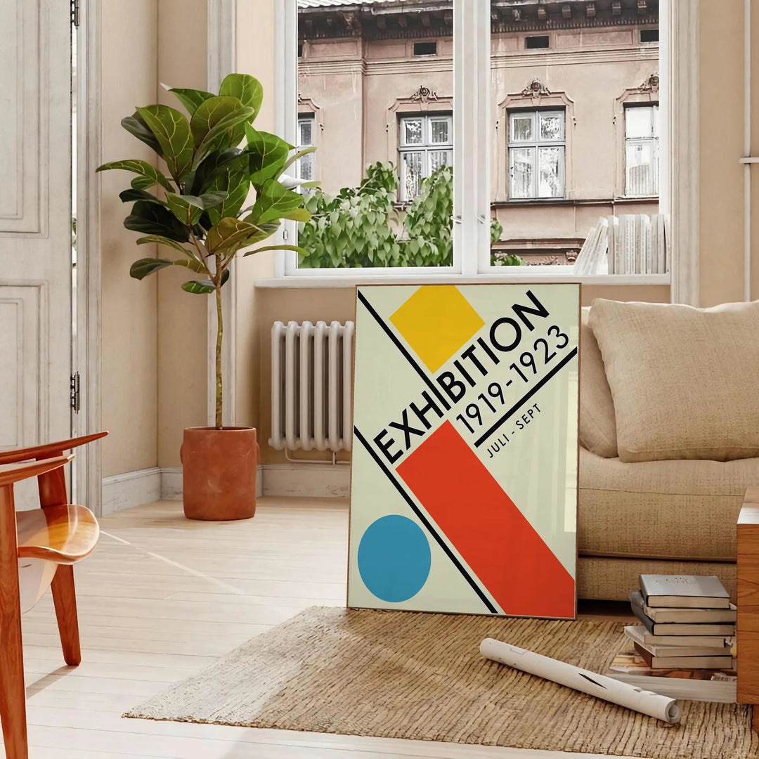 Abstract geometric shapes in a minimal Bauhaus style with a limited color palette - in a Parisian living room with a sofa and a fig plant