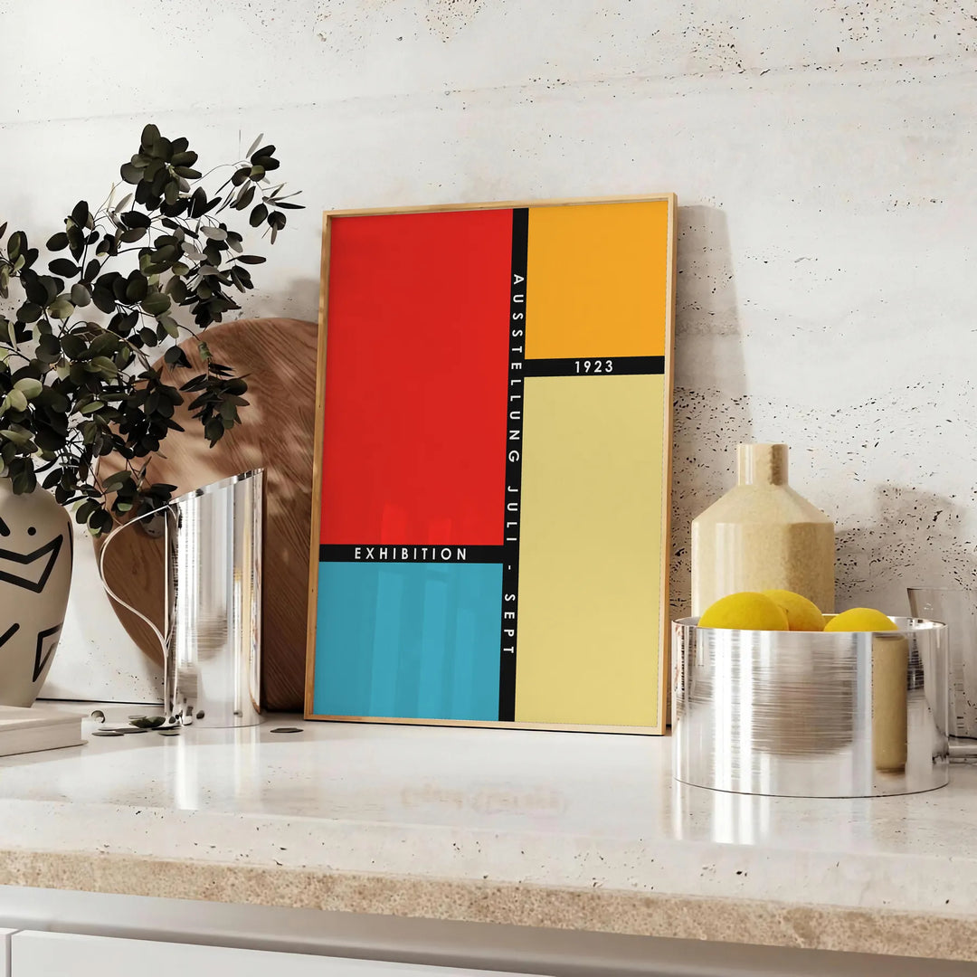 Bauhaus geometric art poster showing abstract shapes and minimal composition - styled on a counter with eucalyptus and a bowl of lemons