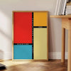 Bauhaus geometric art poster showing abstract shapes and minimal composition - beside a round wooden side table with books