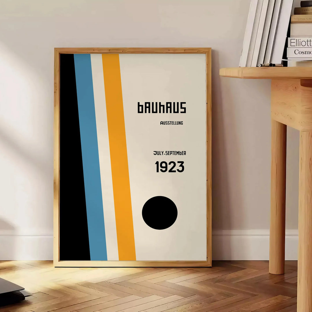 Gray and white Bauhaus geometric abstract art poster, minimalist design - beside a round wooden side table with books