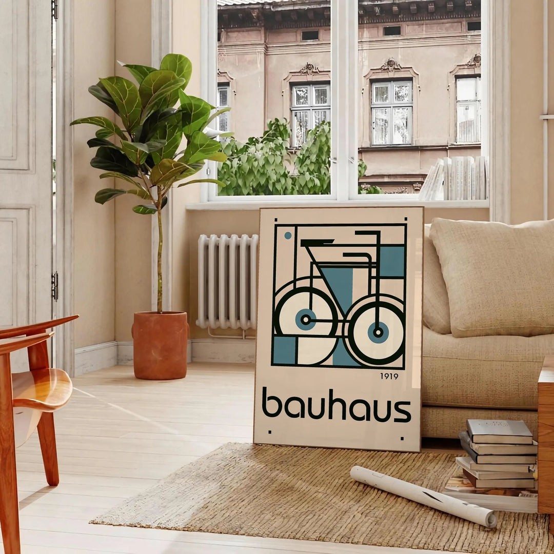 Minimalist poster of a bicycle in Bauhaus style with geometric shapes - in a Parisian living room with a sofa and a fig plant