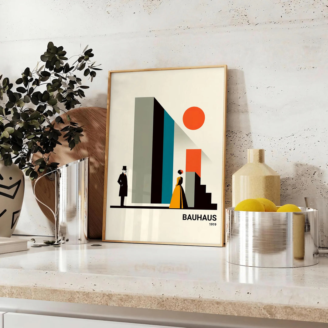 Bauhaus poster of stylized human figure in orange and white - styled on a counter with eucalyptus and a bowl of lemons