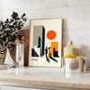 Poster showing a Bauhaus-style human figure in minimalist geometric composition - styled on a counter with eucalyptus and a bowl of lemons