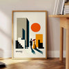 Poster showing a Bauhaus-style human figure in minimalist geometric composition - beside a round wooden side table with books