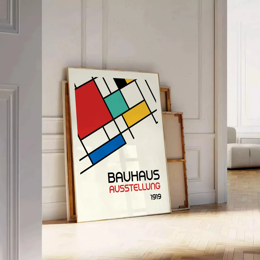 Bauhaus poster showing abstract geometric composition with modern minimalist design - leaning on a herringbone floor against a white panelled wall