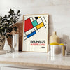 Bauhaus poster showing abstract geometric composition with modern minimalist design - styled on a counter with eucalyptus and a bowl of lemons