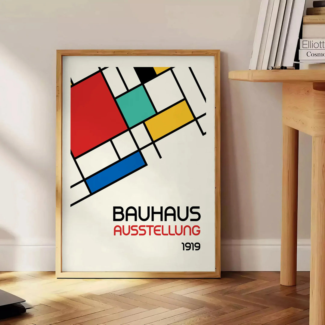 Bauhaus poster showing abstract geometric composition with modern minimalist design - beside a round wooden side table with books