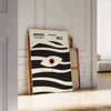 Poster showing geometric abstract Bauhaus composition with bold shapes - leaning on a herringbone floor against a white panelled wall