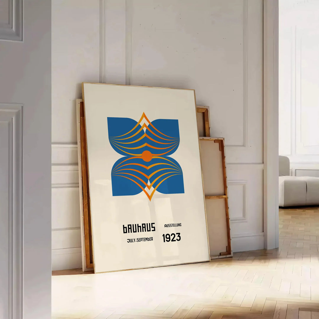 Bauhaus poster showing abstract geometric composition in minimalist modernist style - leaning on a herringbone floor against a white panelled wall