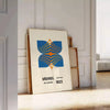 Bauhaus poster showing abstract geometric composition in minimalist modernist style - leaning on a herringbone floor against a white panelled wall
